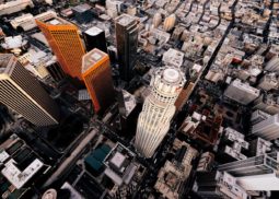 Aerial view of city with heliport landing area identified on top of building